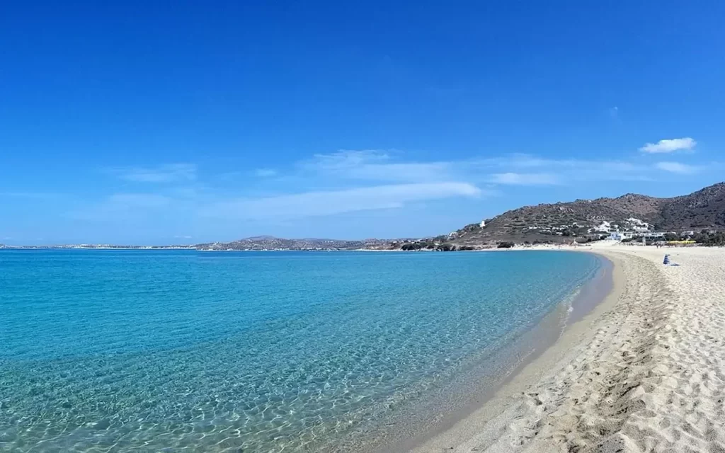 Explore secluded beaches where the turquoise waters sparkle endlessly in Paros